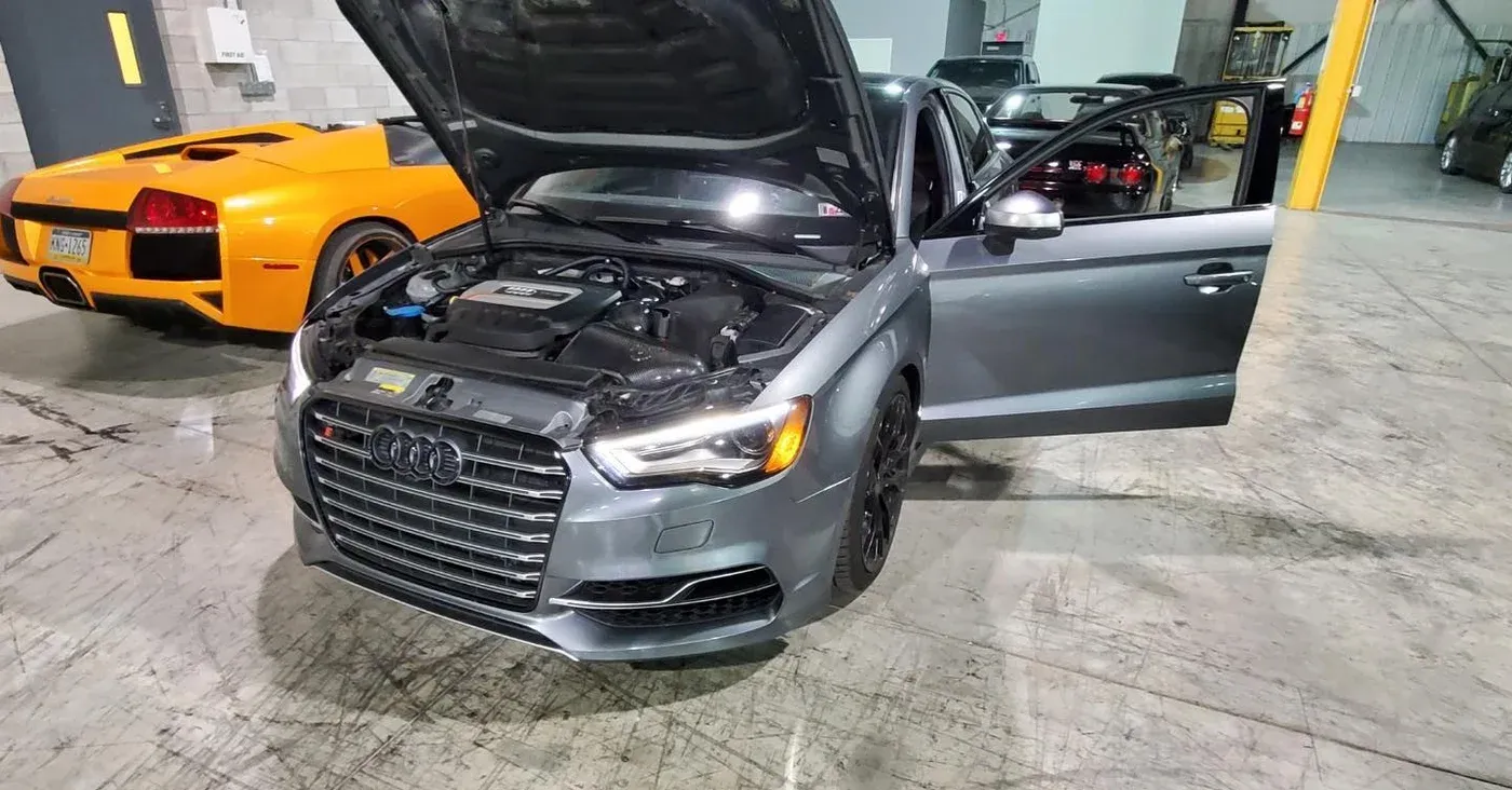 Gray Audi B8 S4 with its hood open in the shop