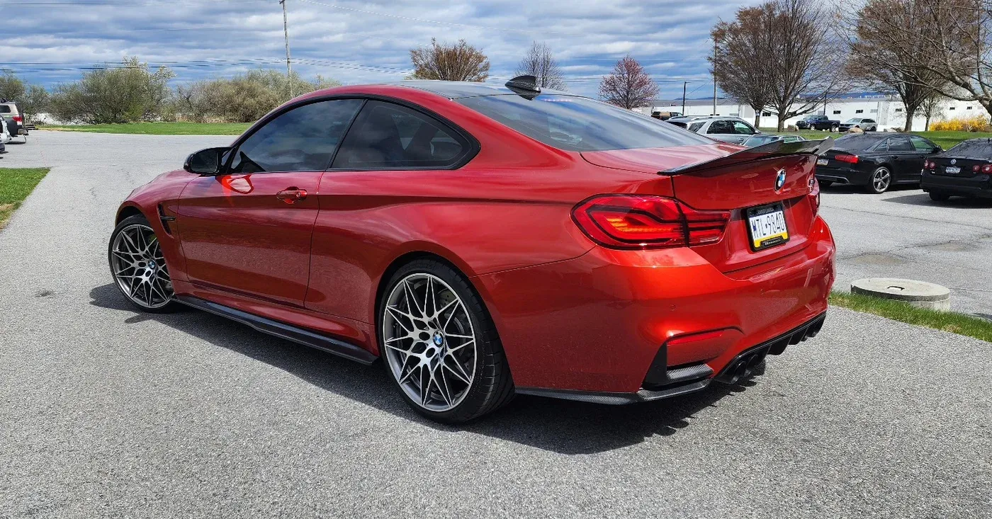 Sakhir Orange BMW M4 outside the shop