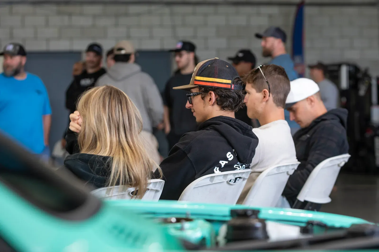 The audience gathers around the dyno bay.