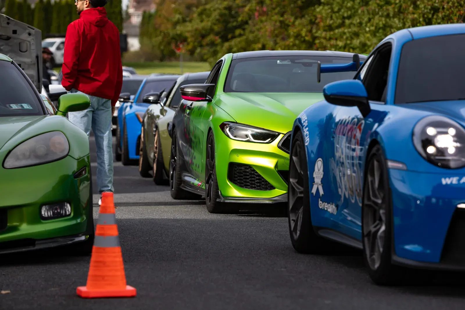 A green BMW and blue Porsche in the lineup.