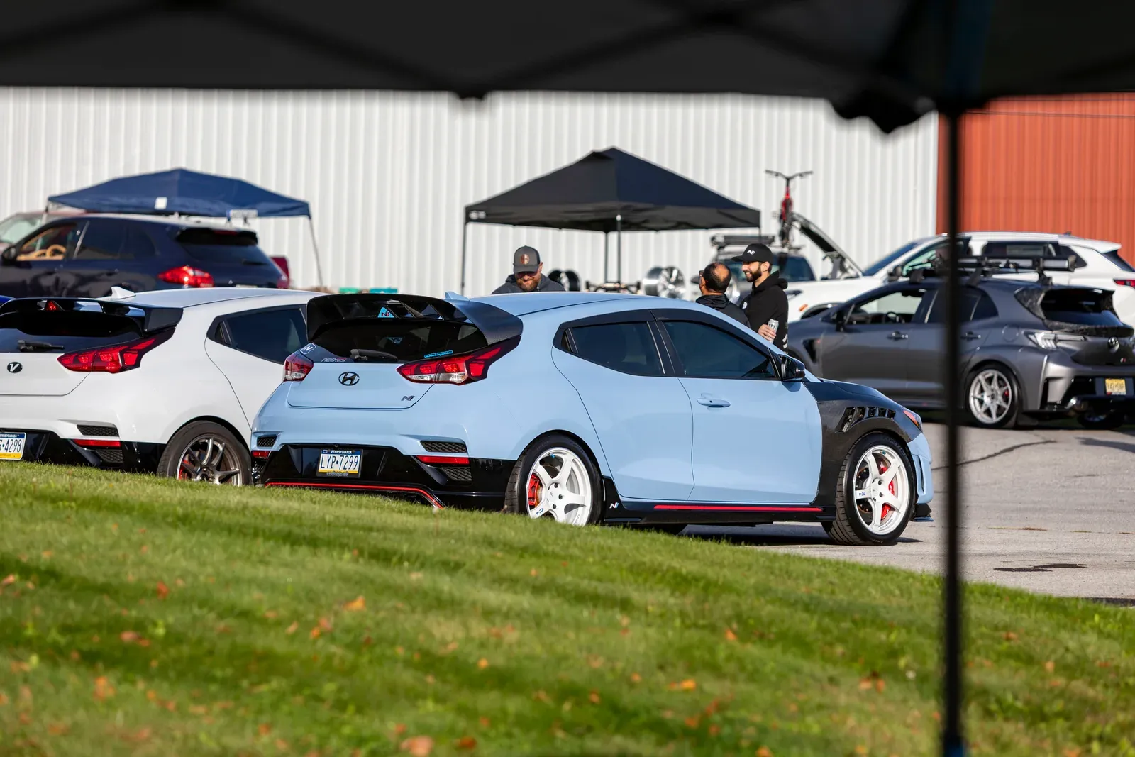Hatchbacks gathered near the vendor tents.