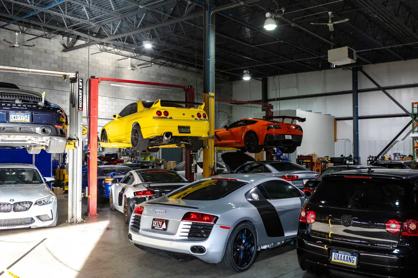 An Audi and other performance cars inside the service area.
