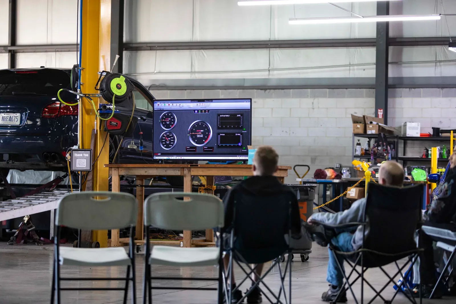 Spectators watch the dyno display from the seating area.