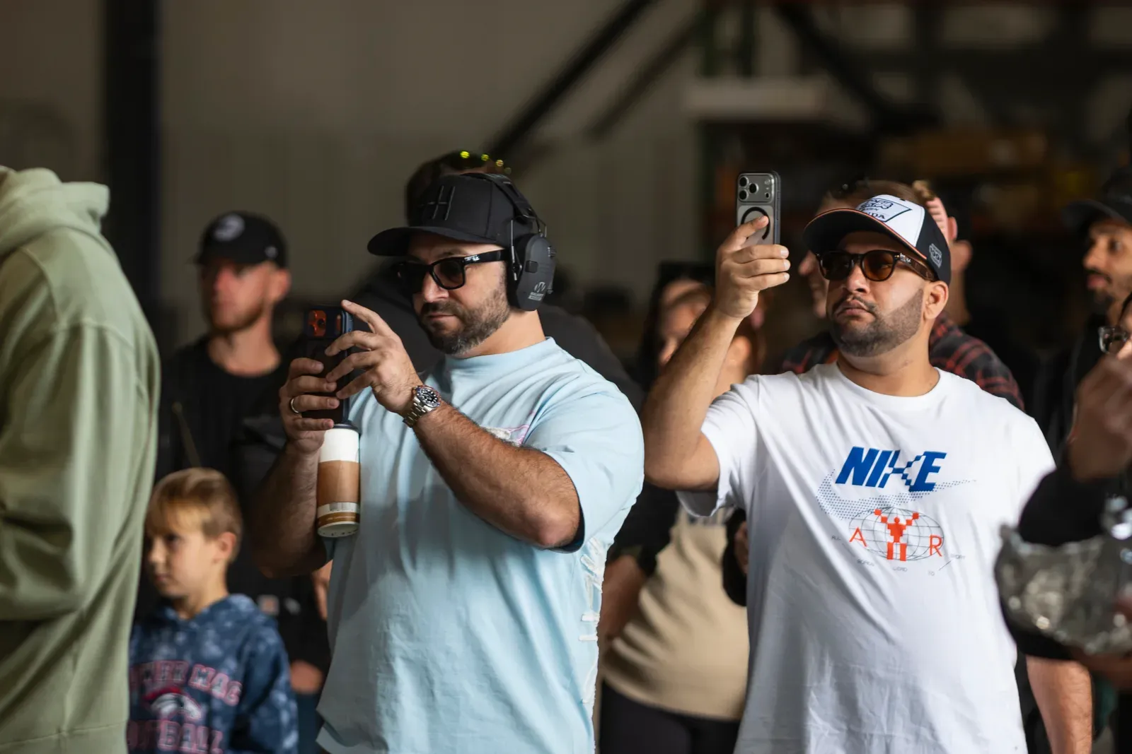 Spectators capture the action on their phones.