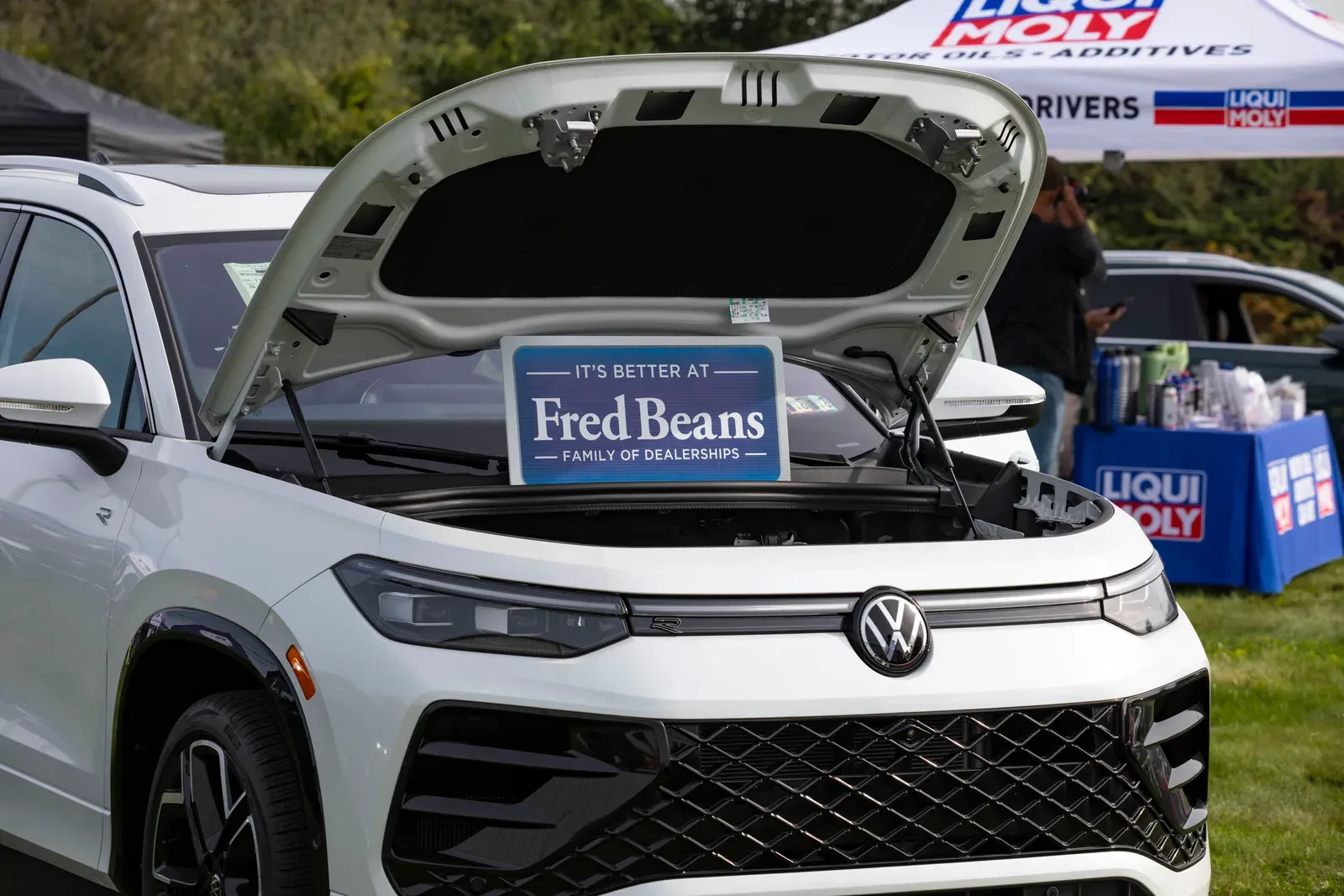 A Volkswagen on display beside the vendor tents.
